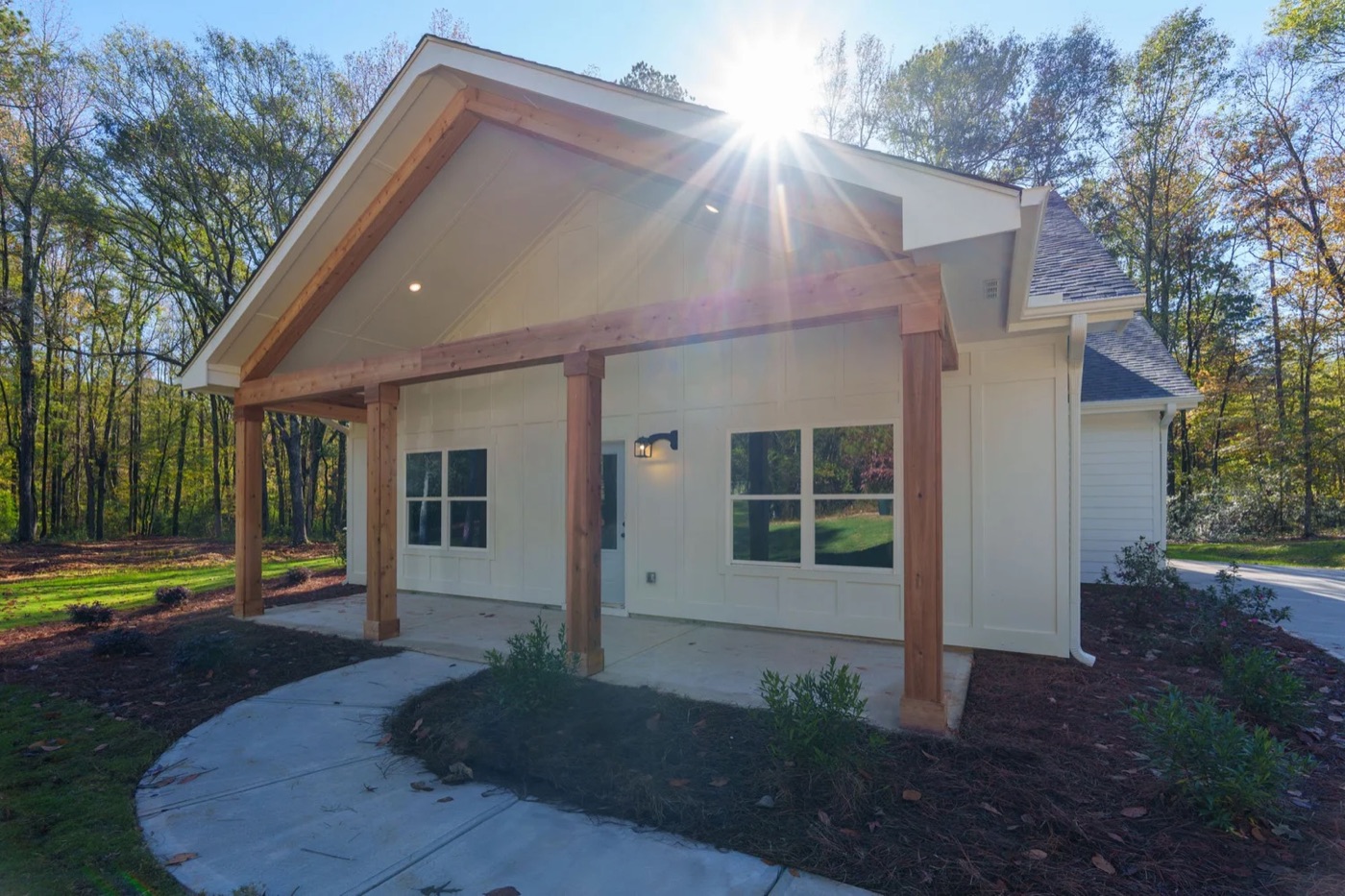 The Belmont Park, a white home with a cedar-post gabled porch