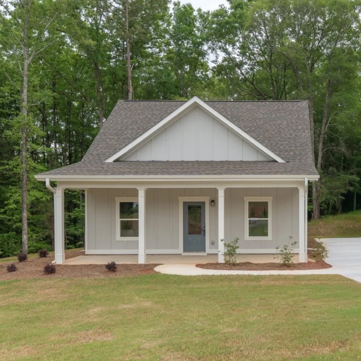 The Del Mar, a gray cottage with a covered front porch