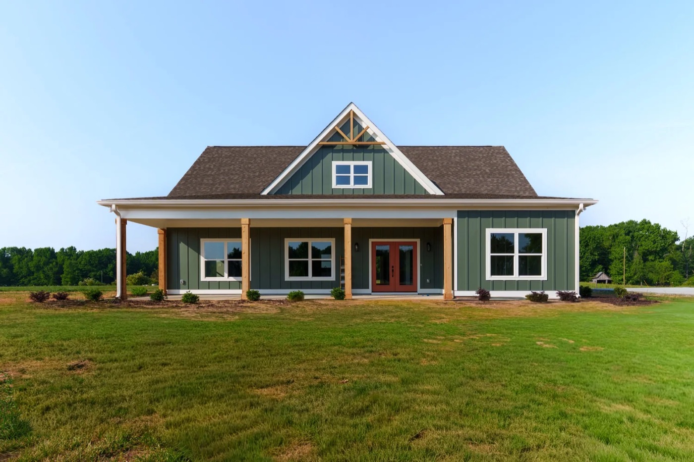 The Peachtree, a sage-green farmhouse with a long front porch